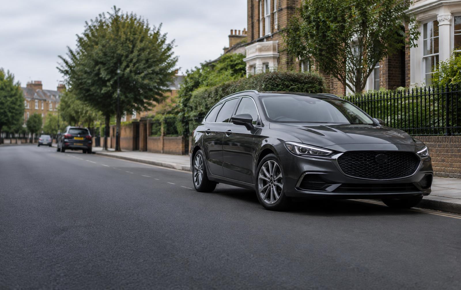 Dark estate car parked on a British residential street